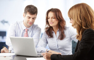 Agents looking at laptop